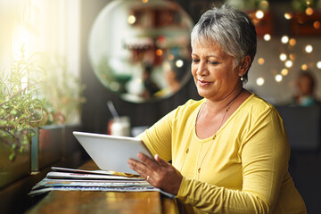 Restaurant, tablet and senior woman typing, research or search internet, web or online website for...