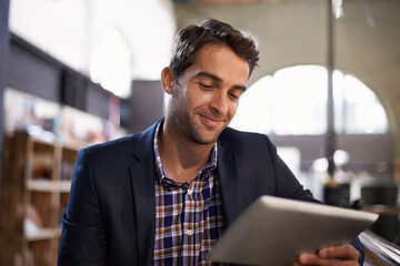 Digital, happy man with tablet and in coffee shop or restaurant. Social media or communication, technology or networking for remote work and male person in cafe store or local pub on mobile device