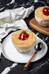Strawberry magnolia. Magnolia dessert in bowl with cream and strawberry. Close up