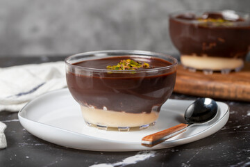 Chocolate supangle dessert. Cream and chocolate pudding or supangle dessert on dark background. Close up