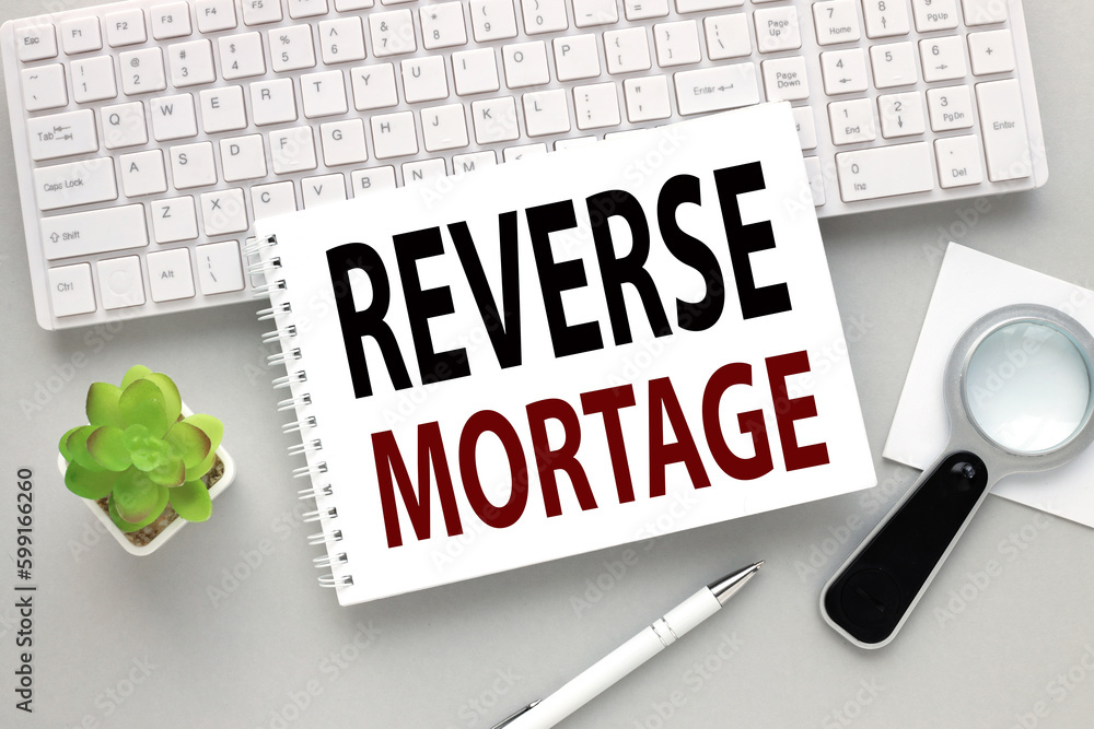 Poster open notepad with reverse mortgage text on white keyboard