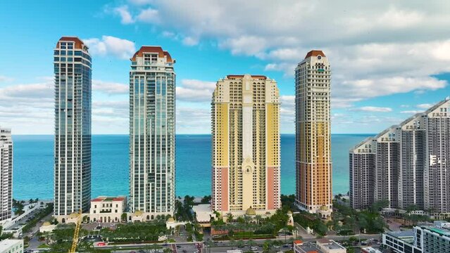 High angle view of Sunny Isles Beach city with expensive highrise hotels and condo buildings on Atlantic ocean shore. American tourism infrastructure in coastal southern Florida