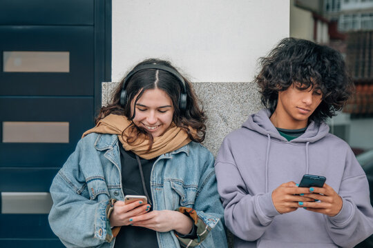teenagers with mobile phone outside