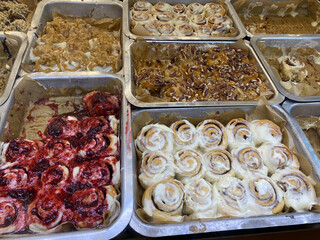 Fresh homemade Cinnamon rolls or Cinnamon buns for sale at showcase of dessert restaurant cafe.