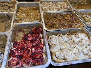 Fresh homemade Cinnamon rolls or Cinnamon buns for sale at showcase of dessert restaurant cafe.