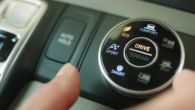 A detail with a sport mode switch in the car. Button for manual selection of sport, eco, comfort driving modes on a modern SUV. The car driver presses the Sport button