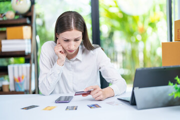 Desperate frustrated bank client woman facing scam, overspending, problems with online payments, blocked credit card, bankruptcy, Stressed woman hold credit card calculating monthly home expenses