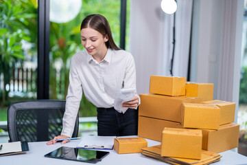 Startup, delivery and shipping in boxes for online shopping business. Businesswoman packing...