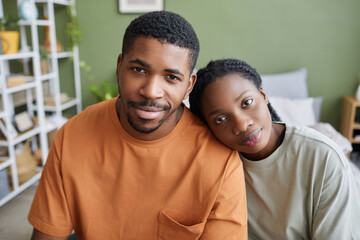 Obraz premium Portrait of African American young couple looking at camera while sitting in bedroom at home