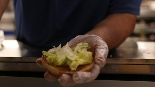 Fast Food Employees Making Burgers.