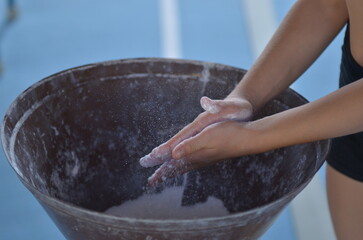 Gymnastics, acrobatics, hands in magnesia