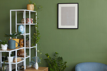 Domestic room with painting on green wall and modern shelves with different objects