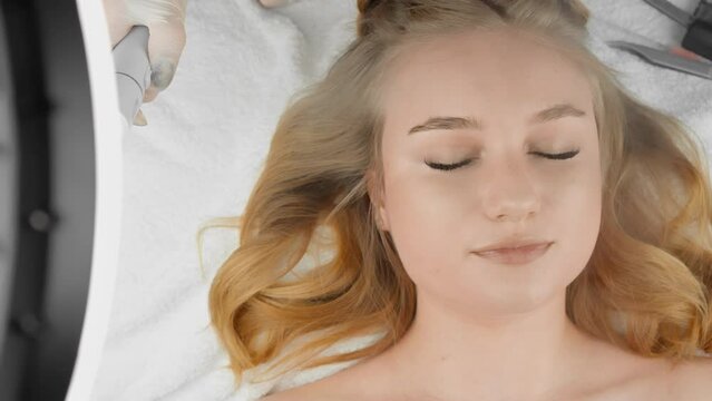 Moisturizing skin face and eyelids. Cosmetology for women: eyelash extension procedure in modern beauty salon. In fat beauty, women with long and beautiful eyelashes created by professional lashmaker