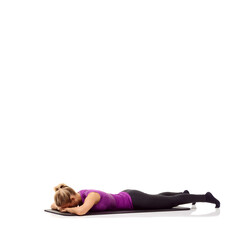 Mentally preparing for a workout. A young woman lying face down on her exercise mat and...