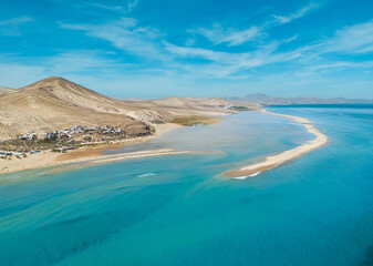 Stunning mid aspect aerial panoramic view of the beautiful tropical looking beach, lagoon and sand dunes at Sotavento Risco del Paso beach near Costa Calma on Fuerteventura Canary Islands Spain - obrazy, fototapety, plakaty