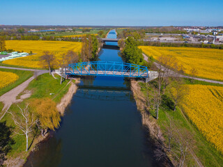 bridge crossing canal in rape fields