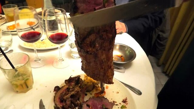 In Brazil, grilling meat on an iron skewer sword, also known as picanha BBQ, is a traditional method. The meat is roasted on the sword and served on a plate at a Brazilian steakhouse.