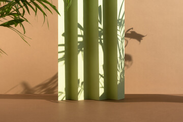 Abstract beige and green background with shadow of palm leaves for the presentation of a cosmetic product. A scene with a geometric backdrop. Podium for product promotion, beauty, natural eco cosmetic