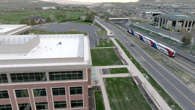 A commuter train transporting people between the suburbs and city - aerial