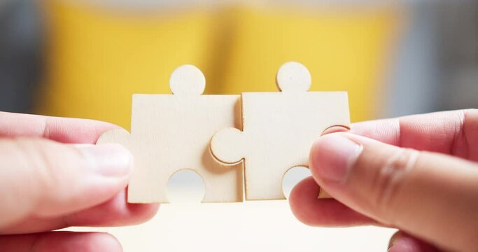 Close Up Hands of Men Connecting Jigsaw Puzzle. Business Solutions, Success Strategy. Two Hands Connect Couple Puzzle. One Part of Whole Symbol of Association and Connection.