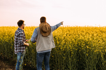 Two farmers standing on their farmland.