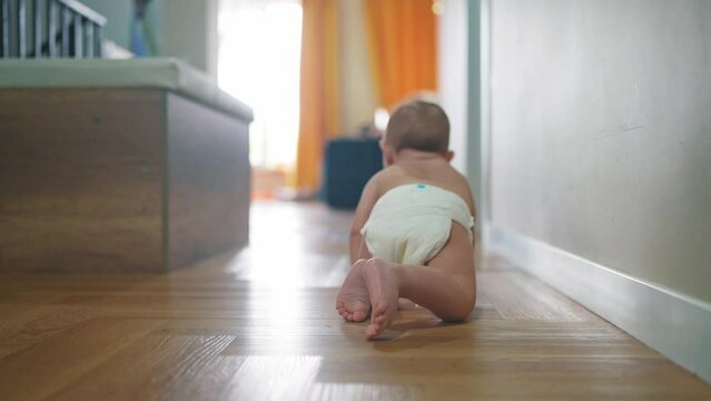 baby son crawling. happy family a first steps kid dream concept. baby newborn crawling down the hallway in the house. happy baby boy crawling on the floor takes lifestyle her first steps