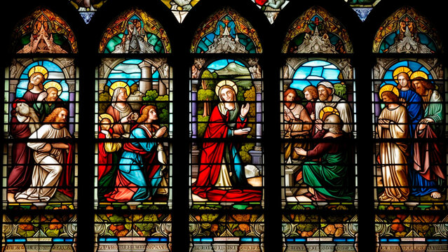 A stunning stained glass window in a church that depicts a religious scene or symbol.