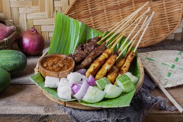 Grilled food chicken and beef satay eaten with peanut sauce is famous Malaysian and Indonesian...