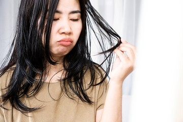 close-up of asian woman's hair issues with oiliness and thinning
