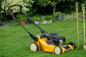 Fototapeta na wymiar Grass mower on the garden