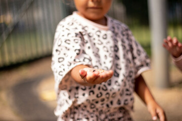 Young Aboriginal girl holding findings at a preschool