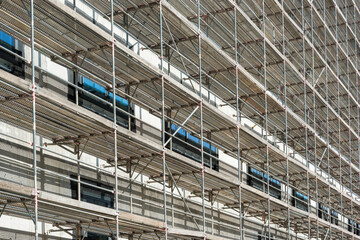A scaffold on a multi-storey facade of a house
