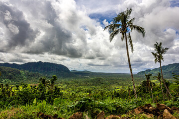 Gray and white cumulus clouds over forested hills at Samoa Upolu island, Atua province, Pacific...