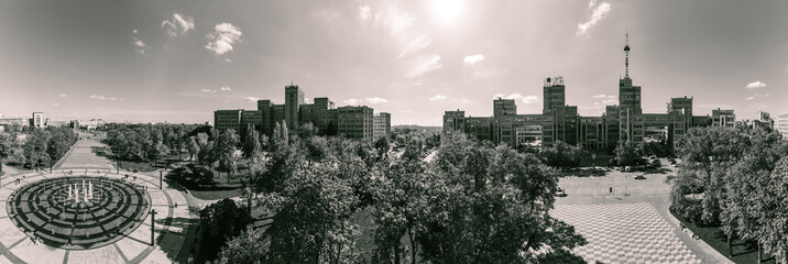 Aerial view on Derzhprom and main Karazin National University buildings on Freedom Square with circle fountain in Kharkiv, Ukraine. Grayscale