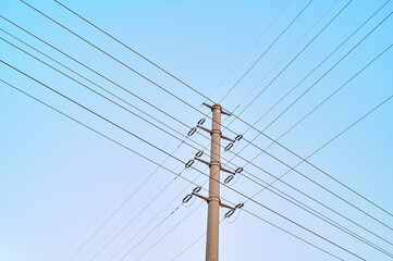 Crossing high-voltage wires against the sky
