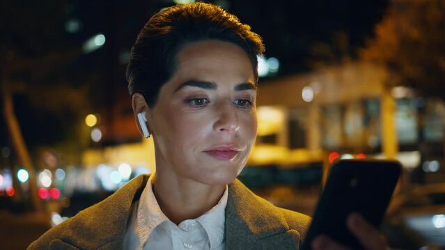 Businesswoman looking smartphone screen at night closeup. Relaxed woman listen