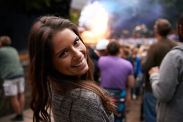 Theyre my favourite band. A pretty young woman enjoying the music at an outdoor festival.