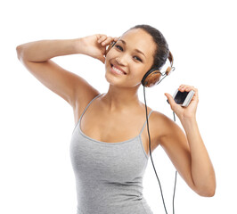 Dancing to the beat. A beautiful young woman listening to music on her headphones.