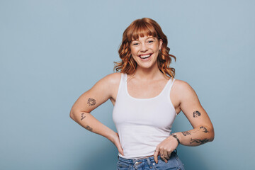 Woman smiling at the camera while standing in a studio