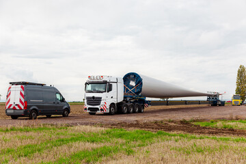 wind turbines under construction. Blade for wind turbines. Special transport of a blade for a wind turbine on a special semi-trailer