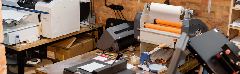 paper trimmer and professional print plotter machine in print center, banner.