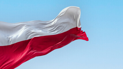 The national flag of Poland waving in the wind on a clear day © rarrarorro