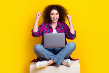 Full length photo of pretty lucky woman dressed plaid shirt winning game modern device isolated yellow color background