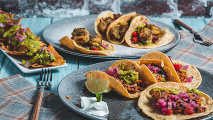 Mexican food, dishes of tacos and nachos.