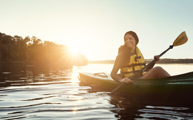 Happiness begins when you start kayaking. a beautiful young woman kayaking on a lake outdoors.