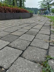 Fototapeta premium Background texture of a close-up cobblestone or paving slabs walkway in Bandung. Can be used for texture design and background with copy space.