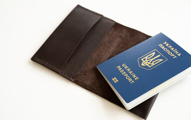 Ukrainian passport with a leather cover on a white background, selective focus. Inscription in Ukrainian Ukraine Passport.