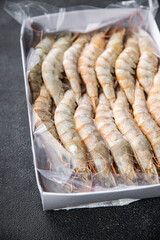 gambas raw frozen in ice big shrimp seafood prawn meal food snack pescatarian diet on the table copy space food background rustic top view keto or paleo