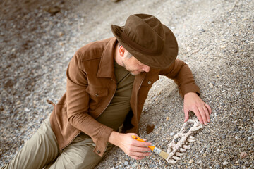 paleontologist archaeologist unearths bones of dinosaur skull