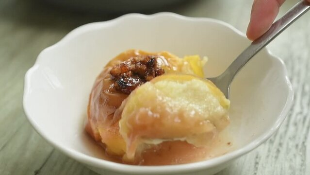Eating freshly prepared baked apple.
